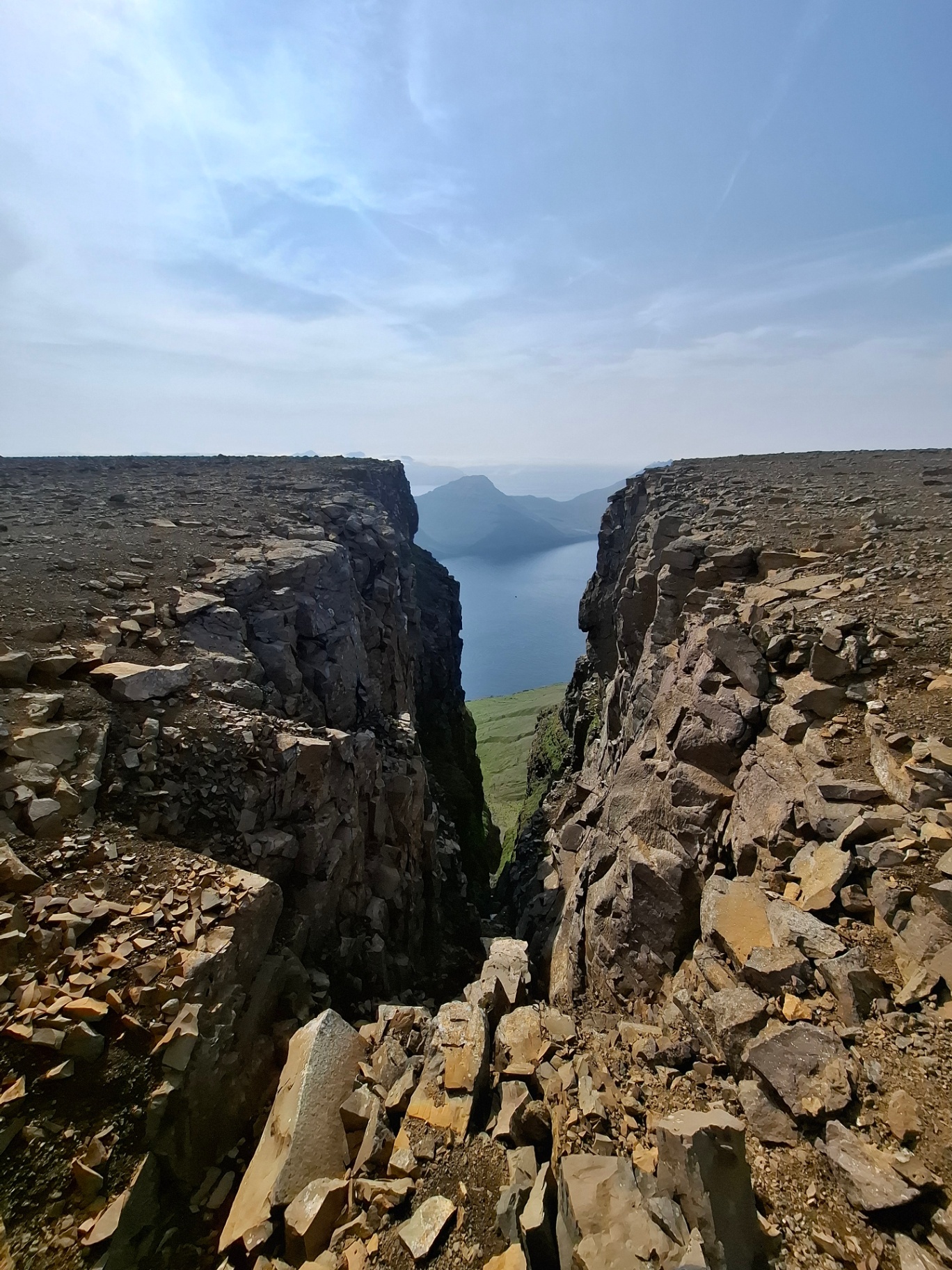 An empty basalt gorge opening onto the Atlantic on a private Faroese trail